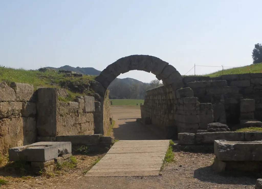 Arched stone entrance to the ancient stadium at Olympia, Greece