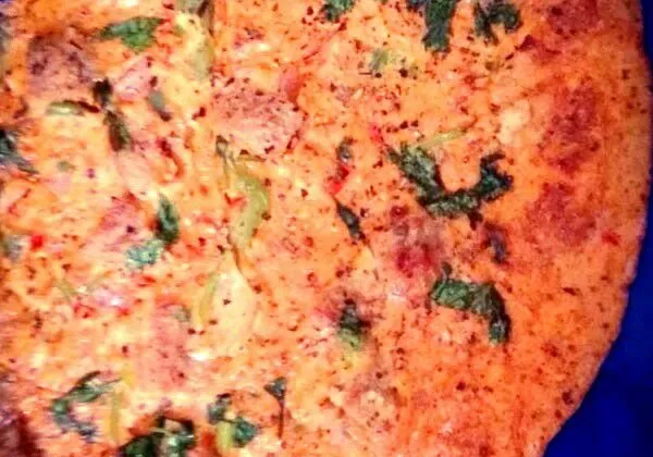 Homemade Sindhi koki, a thick wheat flatbread with onion and spices