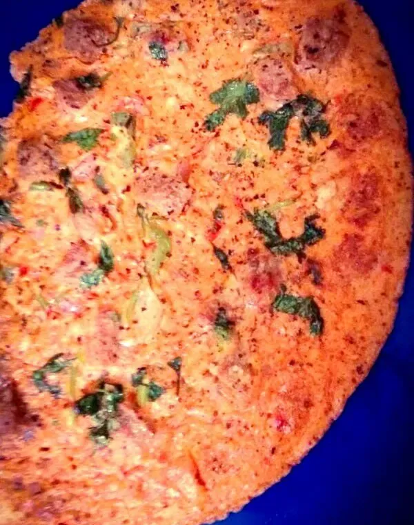 Homemade Sindhi koki, a thick wheat flatbread with onion and spices